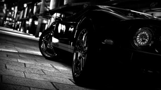Black car brick street night - f 8 aperture free wallpaper