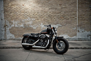 Motorcycle parked brick wall parking - a brick wall behind free wallpaper
