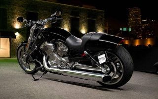 Black motorcycle night building city - a city skyline in the background free wallpaper