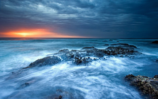 Sunset ocean rocks dark sky 2 - a dark sky in the background free wallpaper