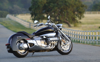 Motorcycle parked road fence grass - a motorcycle free wallpaper