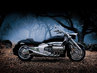 Motorcycle parked wooded area trees - the air above free wallpaper