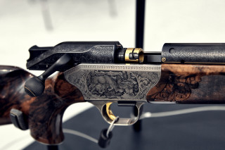 Gun closeup table black background - a close up of a gun free wallpaper