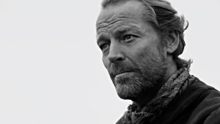 Man beard scarf looking distance - a white sky in the background free wallpaper
