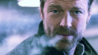 Man beard jacket smoking cigarette - a blurry background free wallpaper