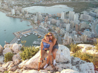 Women mountain overlooking city bay - zenith view free wallpaper