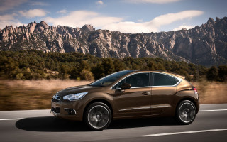 Brown car driving road mountains - didier mouron free wallpaper