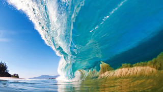 Large wave breaking beach island - a small island in the background free wallpaper