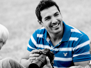 Man sitting camera woman smiling - ahmed karahisari free wallpaper