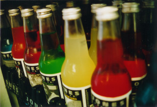 Soda bottles colored drinks row - colored free wallpaper