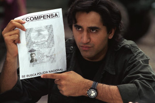 Man holding paper picture man - it in front free wallpaper
