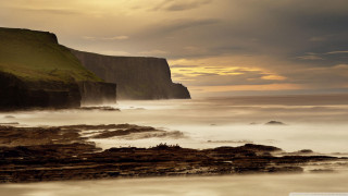 Rocky beach cliff water cloudy - a cloudy sky free wallpaper