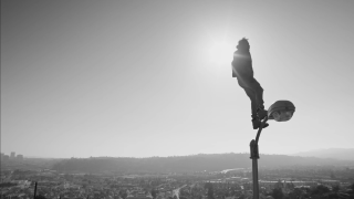 Person standing pole hat city - video art free wallpaper