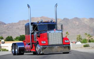 Red semi truck street mountains - a red semi truck free wallpaper
