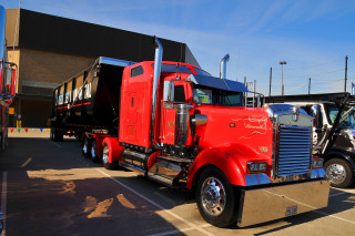 Red semi truck parking lot - a red semi truck free wallpaper