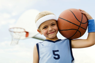 Young boy holding basketball smiling - young free wallpaper