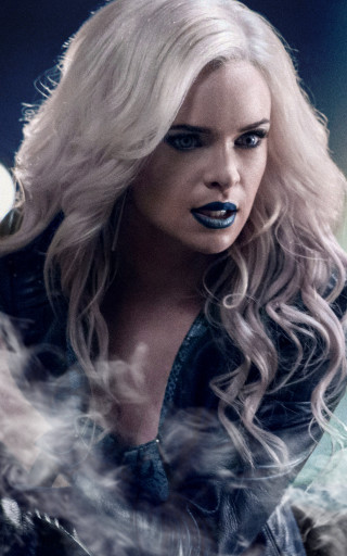Blonde woman blue makeup smoking - a man in the background free wallpaper
