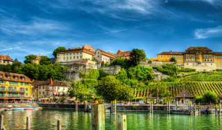 Scenic town hill river boats - a hill in the background free wallpaper