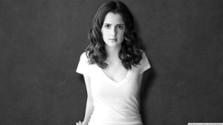 Woman white shirt leaning wall - her right hand free wallpaper