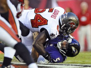 Football player tackled on field - a crowd watching free wallpaper