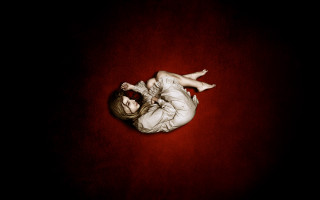 Woman laying floor head down - her stomach free wallpaper