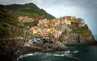 Cliff village ocean boat mountain - the water and a mountain in the background free wallpaper