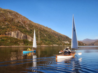 Small boats lake mountain person - top of a lake next free wallpaper