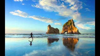 Beach walking person rock formation - beautiful scenery free wallpaper