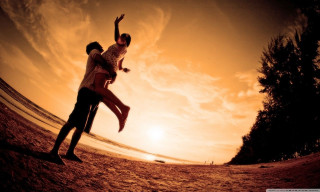 Beach sunset man woman orange 2 - a man and woman free wallpaper