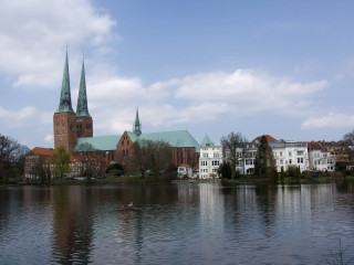 Lake church buildings bird water - a church in the background free wallpaper