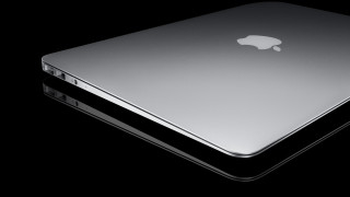 Silver apple laptop black surface - a black surface free wallpaper