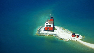 Small red white lighthouse island - a small island in the middle of the ocean free wallpaper