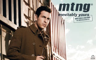 Man trench coat leaning building - his hand and a sign free wallpaper