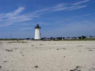 Lighthouse sandy beach blue sky - a sandy beach free wallpaper