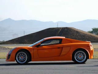 Bright orange sports car mountains 2 - a parking lot free wallpaper