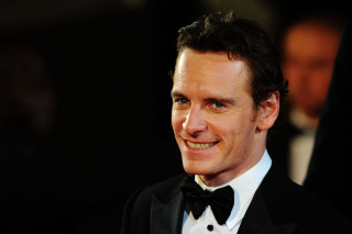 Smiling man tuxedo black background - facial muscle free wallpaper