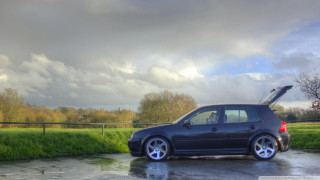 Car parked cloudy sky grass - a parking lot free wallpaper