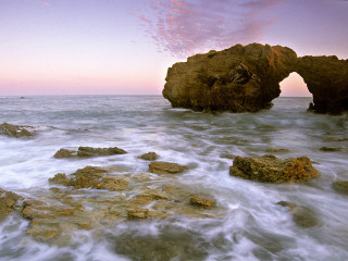 Rocky beach rock formation pink - a pink sky in the background free wallpaper