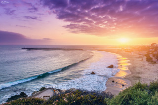 Sunset beach wave pier person - a sunset over a beach free wallpaper