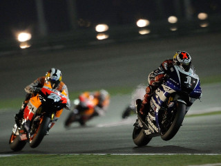 Three motorcyclists racing track nighttime - the corner free wallpaper