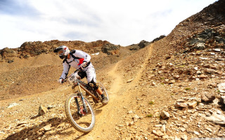 Man bike dirtroad mountain rocks - a mountain side free wallpaper