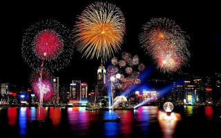 Fireworks city night crowd water - free new year wallpaper