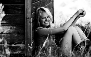 Woman sitting grass smiling camera - eva švankmajerová free wallpaper