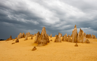 Rocks desert cloudy sky person - a group of rocks free wallpaper