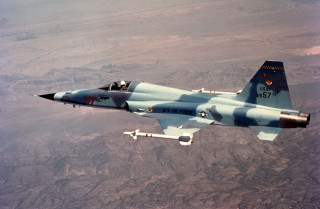 Fighter jet flying mountain range - 100mm free wallpaper