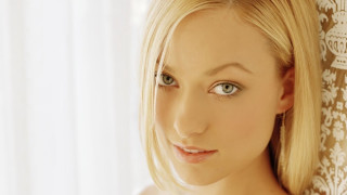 Blonde blue eyes woman posing - a curtain behind her free wallpaper