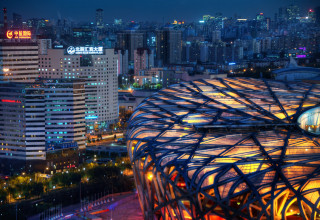 Large metal rooftop structure city - night free wallpaper