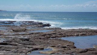 Person walking rocky beach surfboard - australian tonalism free wallpaper for desktop