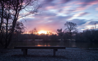 Bench gravel lake sunset setting - a bench free wallpaper