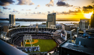 Baseball stadium sunset water city - a sunset in the background and a body of water free wallpaper